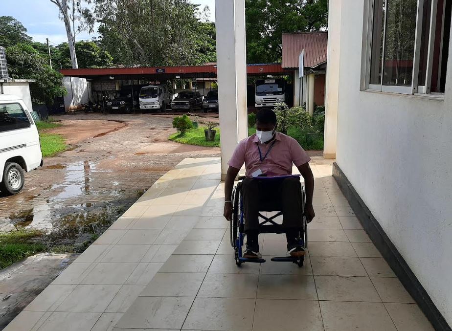 Wheelchair user checking accessibility of the ramp